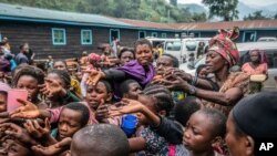 People who fled Goma, Congo, gather at a food distribution point May 28, 2021, in Sake.