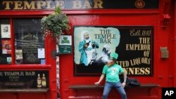 A man dressed up for St Patricks Day outside Temple Bar in Dublin city centre, Tuesday March 17, 2020. The St Patrick's Day parades across Ireland were canceled due to the outbreak of Covid-19 virus. For most people, the new COVID-19 coronavirus…