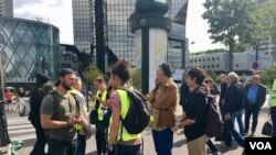 Yellow vest protesters wait near the Seine River for other members to join them, Sept. 7, 2019. 