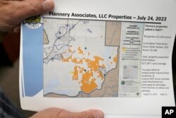 Mayor Ron Kott holds a map showing land acquisitions by Flannery Associates at City Hall in Rio Vista, Calif., Wednesday, Aug. 30, 2023. Silicon Valley billionaires and investors are behind a years-long, secretive land buying spree of more than 78 square miles (202 square kilometers) of farmland in Solano County with the goal of creating a new city. (AP Photo/Godofredo A. Vásquez)