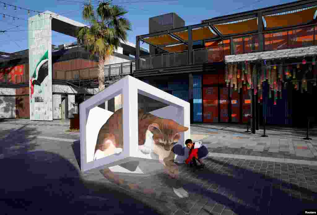 A boy looks at a 3D installation at Dubai Canvas in Dubai, United Arab Emirates.