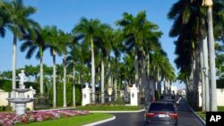 FILE - The motorcade with President Donald Trump, drives into the Trump International Golf Club in West Palm Beach, Florida, Nov. 21, 2018. 