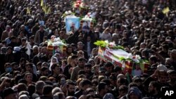 Syrian Kurds attend a funeral of people killed in Turkish airstrikes in the village of Al Malikiyah , northern Syria, Nov. 21, 2022. 