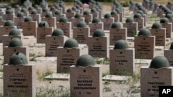 FILE - Graves of Russian World War II soldiers are seen in a cemetery in Rossoshka, near Volgograd, formerly Stalingrad, Russia, June 17, 2018.