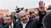 Armenian president Armen Sarkissian greets demonstrators in the Republic Square gathered to protest the former president's shift into the prime minister's seat in Yerevan, Armenia, April 21, 2018. 