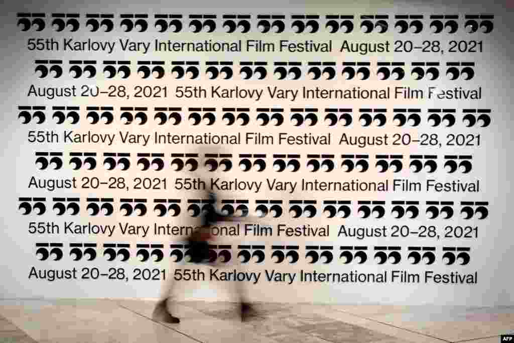 A film fan walks past a banner during the 55th Karlovy Vary International Film Festival (KVIFF) in A film fan walks past a banner during the 55th Karlovy Vary International Film Festival (KVIFF) in Karlovy Vary, Czech Republic.