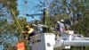 Pike Corporation linemen, from North Carolina, work on power lines damaged by Hurricane Milton, Oct. 14, 2024, in Lithia, Florida.