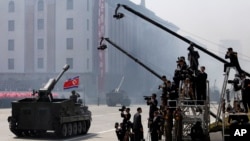 FILE - North Korean artillery pass by North Korean journalists during a military parade in Kim Il Sung Square in Pyongyang, April 15, 2012.