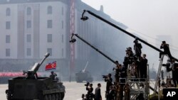 FILE - North Korean artillery pass by North Korean journalists during a parade in Kim Il Sung Square in Pyongyang, April 15, 2012.