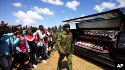 Supporters of Kenyan marathon runner Kelvin Kiptum take photos his casket head of a public viewing of his body, in Elgeyo Marakwet, Kenya, on February 22, 2024.