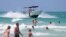 Members of Miami Beach Ocean Rescue keep an eye on swimmers due to the high risk of rip currents in the area Tuesday, July 19, 2016, on South Beach in Miami Beach, Florida.