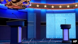 Clear protective panels stand on stage between lecterns for President Donald Trump and Democratic presidential candidate, former Vice President Joe Biden, ahead of their debate at Belmont University, in Nashville, Tennessee, Oct. 21, 2020.