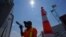 John Ford, a worker with the Port of Seattle, paints near a railing at the Bell Street Cruise Terminal at Pier 66, June 30, 2021, in downtown Seattle. 