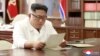 North Korean leader Kim Jong Un reads a letter from U.S. President Donald Trump, in Pyongyang, North Korea, in this picture released by North Korea's Korean Central News Agency, June 22, 2019.