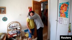 Relatives hug each other at the bedroom of Israeli girl, Hallel Yaffa Ariel, 13, who was killed in a Palestinian stabbing attack in her home in the West Bank Jewish settlement of Kiryat Arba, near the West Bank city of Hebron June 30, 2016.