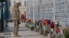 A serviceman mourns at the Memorial Wall of Fallen Defenders of Ukraine in Russian-Ukrainian War in Kyiv, Ukraine, Feb. 24, 2025.