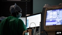 FILE - A nurse works at a COVID-19 intensive care unit of a hospital in Saint-Denis, France, on Dec. 29, 2021. The World Health Organization said on Aug. 6, 2024, that many countries are not prepared for a global surge of COVID-19.