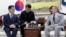 South Korean Unification Minister Kim Yeon Chul, left, meets with U.S. Ambassador to South Korea Harry Harris, right, during their meeting at a government complex in downtown Seoul, South Korea, Tuesday, April 16, 2019.