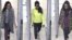 FILE - A combination of handout CCTV pictures received from the Metropolitan Police Service shows, from left, British teenagers Kadiza Sultana, Amira Abase and Shamima Begum passing through security barriers at Gatwick Airport, south of London, on Feb. 17, 2015.
