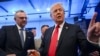 FILE - Then-Republican presidential nominee former President Donald Trump signs autographs as Massad Boulos listens during an event in Dearborn, Michigan, Nov. 1, 2024.