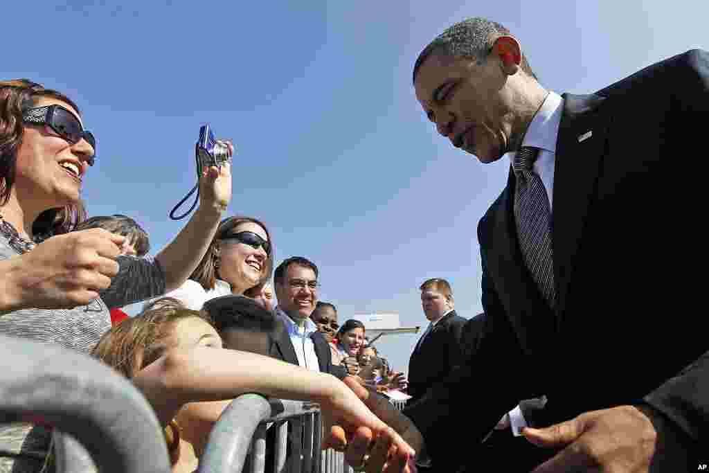 President Barack Obama greets supporters on the tarmac on his arrival at O'Hare International Airport in Chicago, March, 16, 2012. (AP)