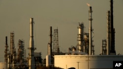 A motorist drives past the CHS oil refinery Sept. 28, 2024, in McPherson, Kan.