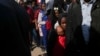 FILE - Migrants from Haiti stand in line outside the Mexican Commission for Refugee Aid government office to apply for asylum in Mexico City, Jan. 28, 2025.