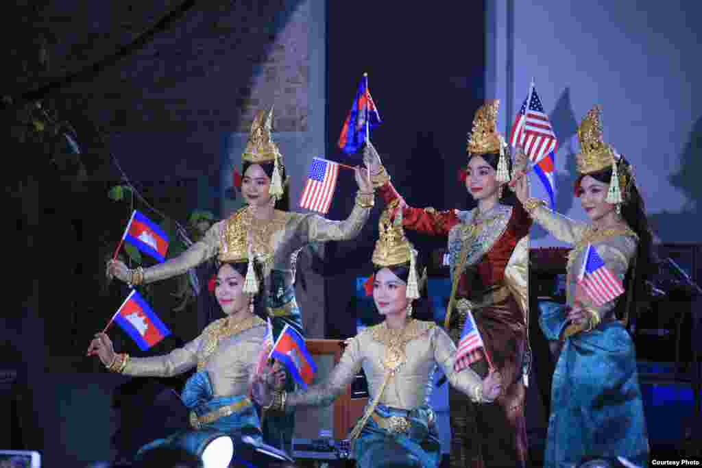 Khmer Apsara dancers holding both American and Cambodian flags open a ceremony to commemorate 70 years of diplomatic ties between the two countries, January 2020. (Photo courtesy of U.S. Embassy in Cambodia) 