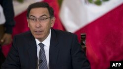 Peruvian President Martin Vizcarra gestures as he speaks, during a press conference with representatives of foreign media in Lima, June 5, 2018. 