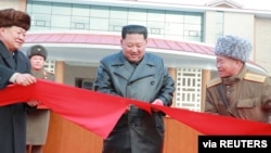 North Korean leader Kim Jong Un cuts a ribbon during a ceremony for the completion of the Yangdok County Hot Spring Cultural Recreation Center in North Korea in this undated picture released by North Korea's Central News Agency (KCNA) on December 7,…