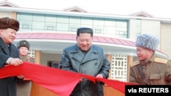 North Korean leader Kim Jong Un cuts a ribbon during a ceremony for the completion of the Yangdok County Hot Spring Cultural Recreation Center in North Korea in this undated picture released by North Korea's Central News Agency (KCNA) on December 7, 2019.