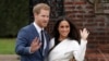 FILE - Britain's Prince Harry and his then-fiancee Meghan Markle pose for photographers on the grounds of Kensington Palace in London on Nov. 27, 2017.