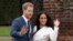 FILE - Britain's Prince Harry and his then-fiancee Meghan Markle pose for photographers on the grounds of Kensington Palace in London on Nov. 27, 2017.