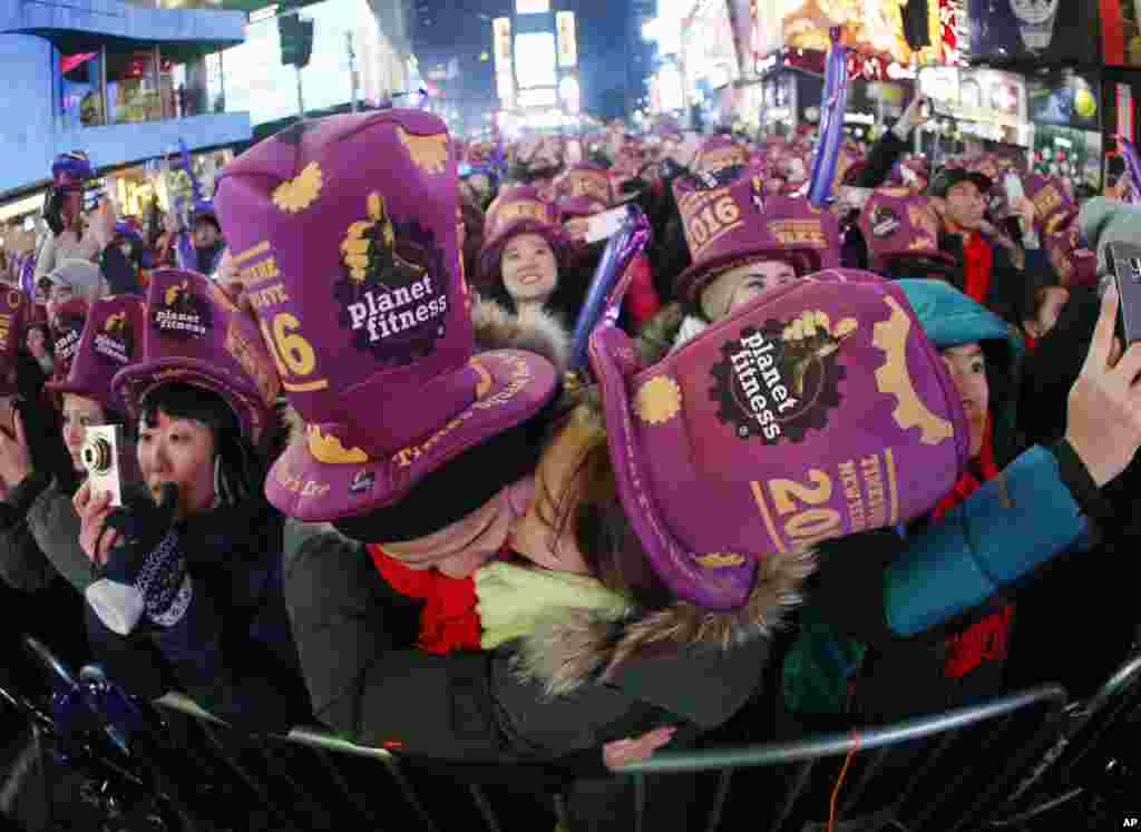 A couple kiss moments before midnight during New Year's Eve celebrations at Times Square, Thursday, Dec. 31, 2015.