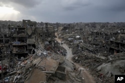 Palestinians walk amid the destruction caused by the Israeli air and ground offensive in Jabaliya, Gaza Strip, Feb. 6, 2025.