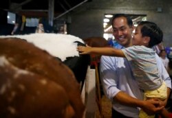 Democratic 2020 U.S. presidential candidate and former HUD Secretary Julian Castro and his son Cristian tour the Iowa State Fair in Des Moines, Iowa, Aug. 9, 2019.