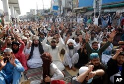 Supporters of Tehreek-e-Labiak Pakistan, a radical Islamist political party, chant slogans during a protest against the arrest of their party leader, Saad Rizvi, in Lahore, Pakistan, April 15, 2021.