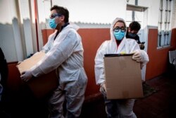 Trabajadores municipales preparan la entrega de cajas con alimentos a las familias económicamente afectadas durante la cuarentena obligatoria ordenada por el gobierno chileno debido a la pandemia de coronavirus COVID-19.