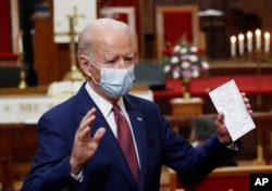 FILE - Democratic presidential candidate, former Vice President Joe Biden holds his notes as he speaks to members of the clergy and community leaders at Bethel AME Church in Wilmington, Del., June 1, 2020.
