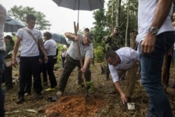 Howard Buffett plants a cocoa plant at a farm in La Gabarra, Colombia, Jan. 29, 2020. Buffett began working in Colombia in 2008, helping pop star Shakira set up schools in her hometown of Barranquilla.