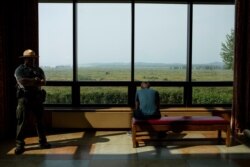 A Grand Teton National Park law enforcement officer stands watch in the lobby outside of the Jackson Hole Economic Policy Symposium on Aug. 24, 2018, at Jackson Lake Lodge.