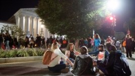 People gather at the Supreme Court to honor the late Justice Ruth Bader Ginsburg, Saturday, Sept. 19, 2020, in Washington. (AP Photo/Cliff Owen)