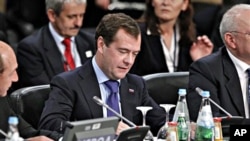 Russian President Dmitry Medvedev, center, participates at the start of the NATO Russia Council Meeting Working Session at the NATO Summit in Lisbon, Portugal, 20 Nov. 2010