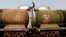 A worker walks atop a tanker wagon to check the freight level at an oil terminal on the outskirts of Kolkata, Nov. 27, 2013. 