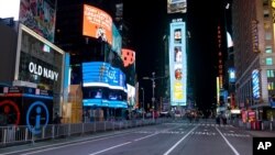 Seventh Avenue is mostly empty during what would normally be a Times Square packed with people, Dec. 31, 2020, in New York, as celebrations were truncated this New Year's Eve because of the ongoing pandemic.