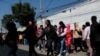 Migrants gather outside of the Mexican Commission for Refugee Assistance (COMAR) in Mexico City