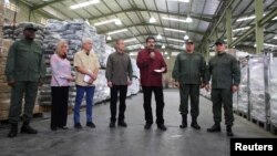 Venezuela's President Nicolas Maduro speaks during his visit to a packing center of the CLAP (Local Committees of Supply and Production) program, a Venezuelan government handout of basic food supplies, in Caracas, Venezuela, April 17, 2019.