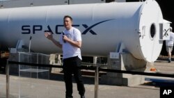 FILE - Telsa CEO Elon Musk congratulates the winners of the Hyperloop Pod Competition II at SpaceX's Hyperloop track in Hawthorne, Calif., Sunday, Aug. 27, 2017.