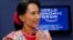 Burma opposition leader Aung San Suu Kyi smiles during a debate with Myanmar President's Office Minister Soe Thane at the World Economic Forum on East Asia at Myanmar International Convention Center in Naypyitaw, June 6, 2013. 