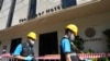 Police forensics team arrive at a hotel in Bangkok, Thailand, Dec. 30, 2024, a day after a fire killed three people. 